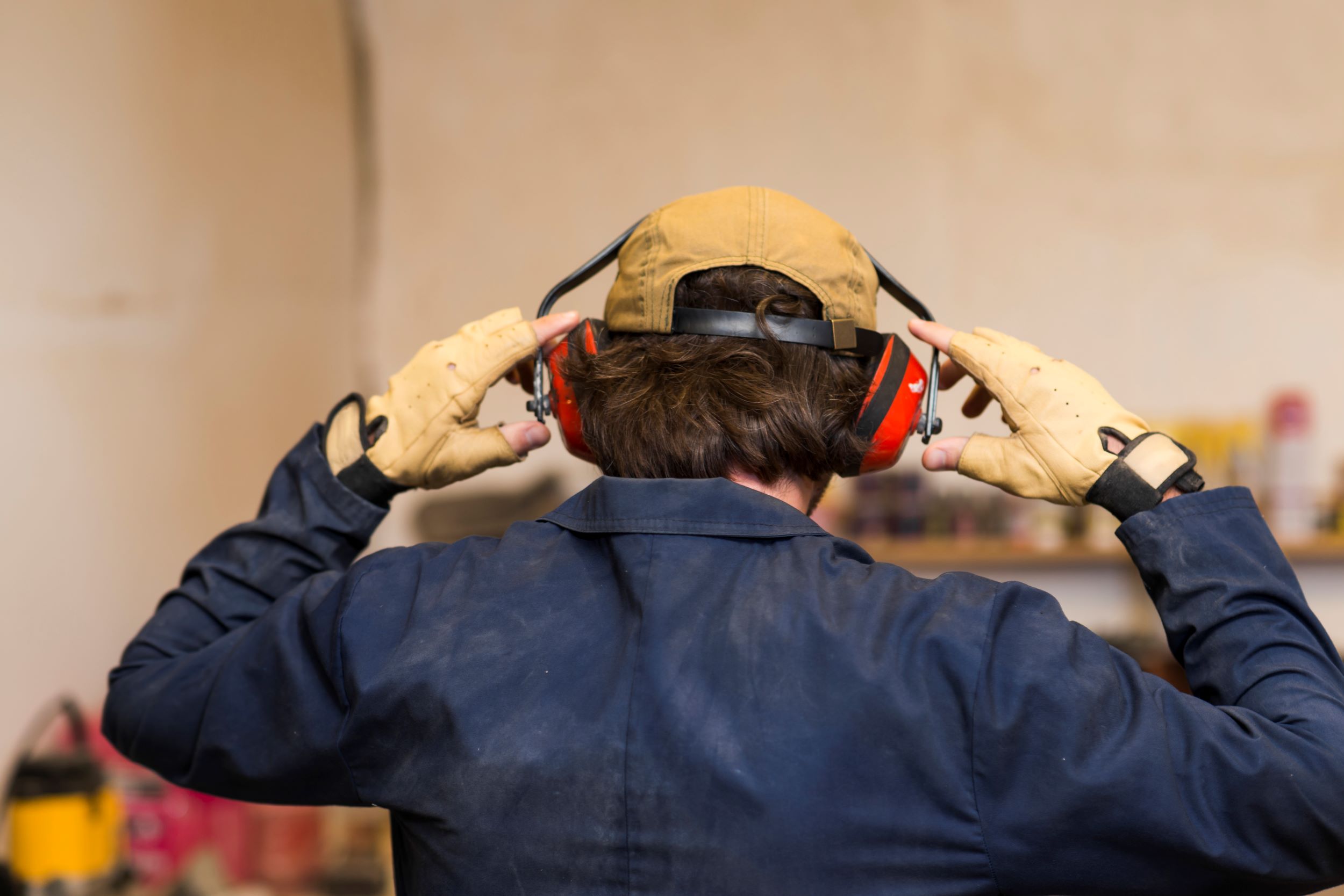 Construction working wearing hearing protection.