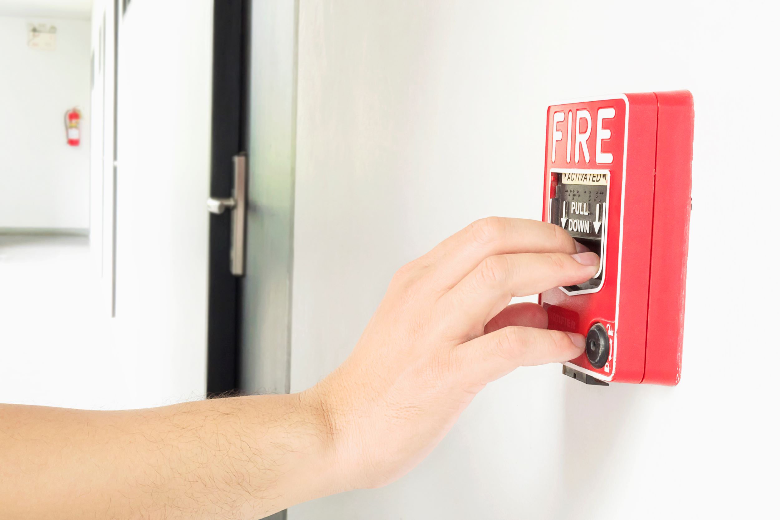 Man switching on fire alarm system